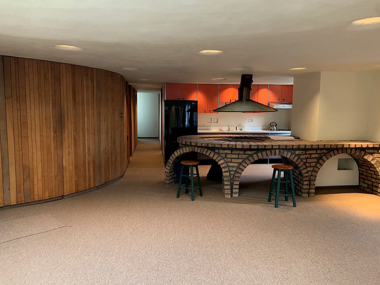 An interior picture of the place, showing the living, dining, and kitchen. Very 1970s.